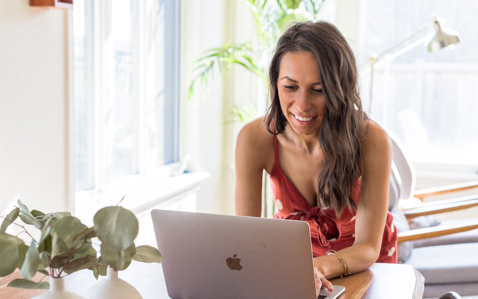 Woman smiling using laptop